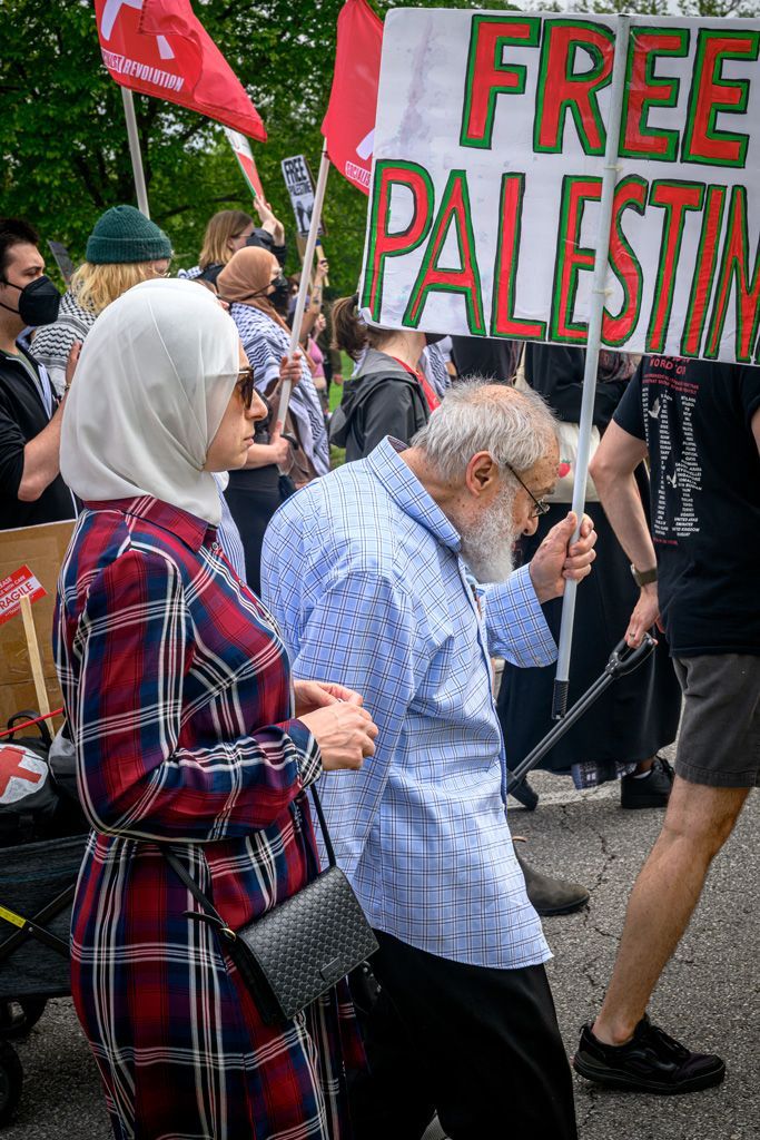 This elderly man, accompanied by his daughter, is old enough to remember when Palestine was partitioned by the United Nations in 1948, which proposed dividing British-mandated Palestine into separate Arab and Jewish states with Jerusalem under international control. Today Israeli Zionist settlers are chipping away at the West Bank by stealing (colonizing) land from Palestinians under the control of the Israeli Defense Forces. Gaza has been obliterated with genocide the form of bombings, snipers, starvation and imposed disease with all but a few hospitals remaining after bombings. Often with little electricity or clean water available. Photographed April 27, 2024.