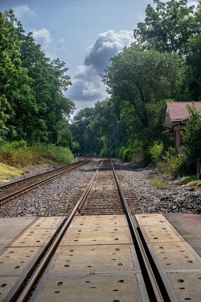 A train track going through an intersection in Webster Groves, MIssouri.
