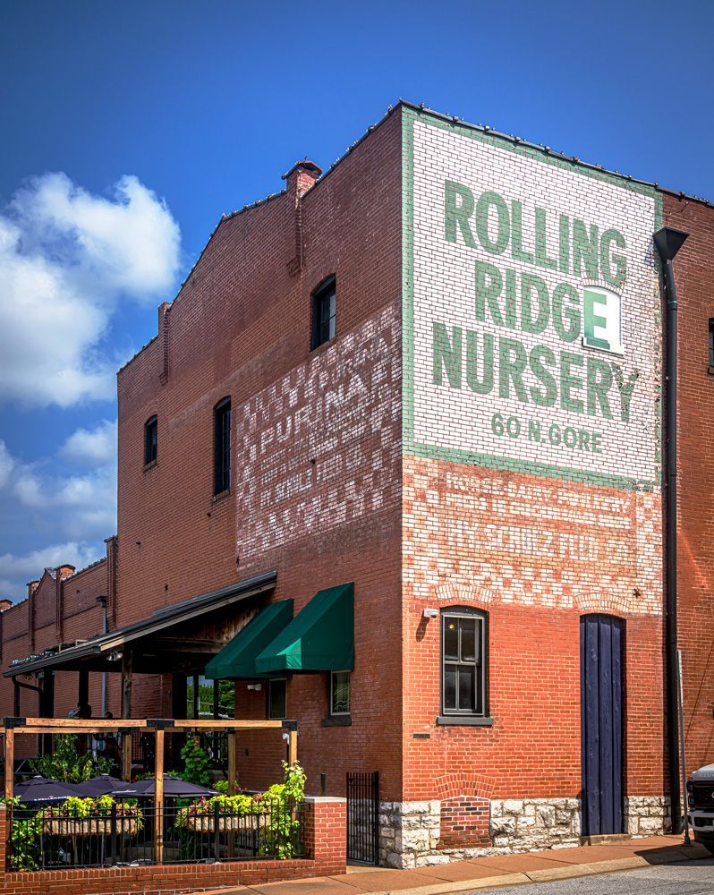 Rolling Ridge Nursery, Webster Groves, Missouri, A brick building with a large sign on the side that says rolling ridge nursery
