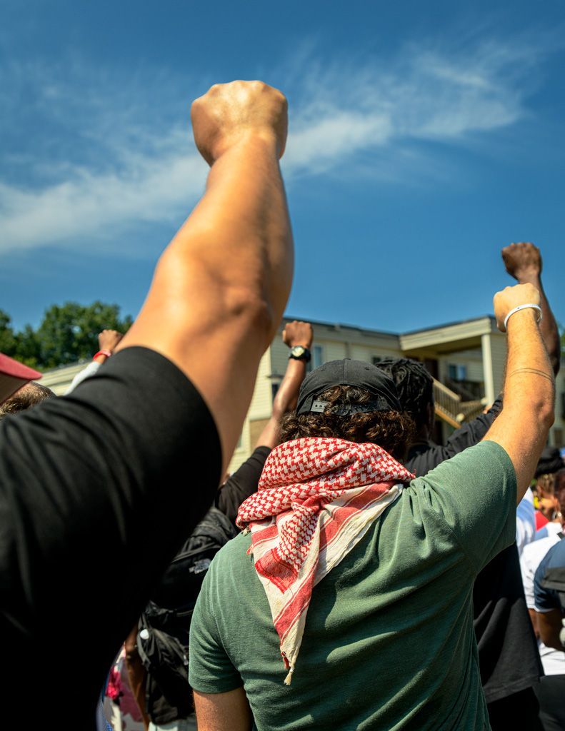 Scene from the 10th anniversary memorial for Michael Brown, Jr.  Along with mournful reverence, there is always a sense that the work of the Black Lives Matter movement is not finished with racism existing in all parts of American society. The raised fist is a graphic symbol of resistance to those who would oppress anyone because of their race, color of skin, gender, religious beliefs, country of origin, or any other factor. Photographed August 9, 2024. 