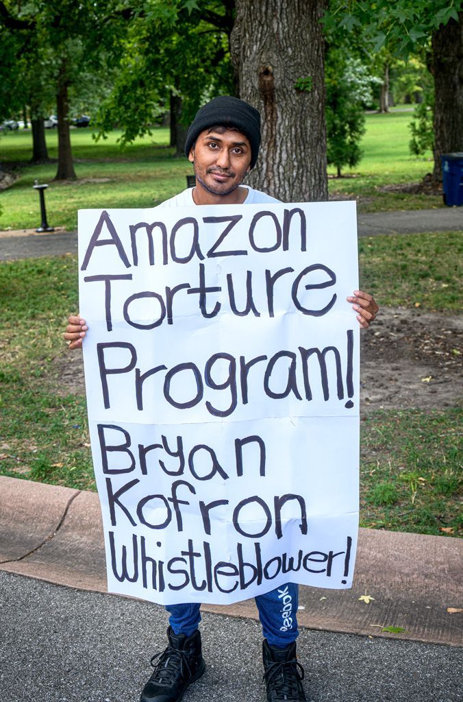 This is a singular demonstration in many ways — he stands alone in his protest No colleagues or supporters. He claims to be a whistleblower for companies maintaining giant databases of human DNA that can (and are) being used by corporations, such as Amazon, in this instance. Verifying the veracity of his claims is difficult because online sources are sketchy and none include reputable mainline media outlets. But, the First Amendment gives this gentleman the right to say what he says and to assemble to say it. Photographed August 23, 2025. 