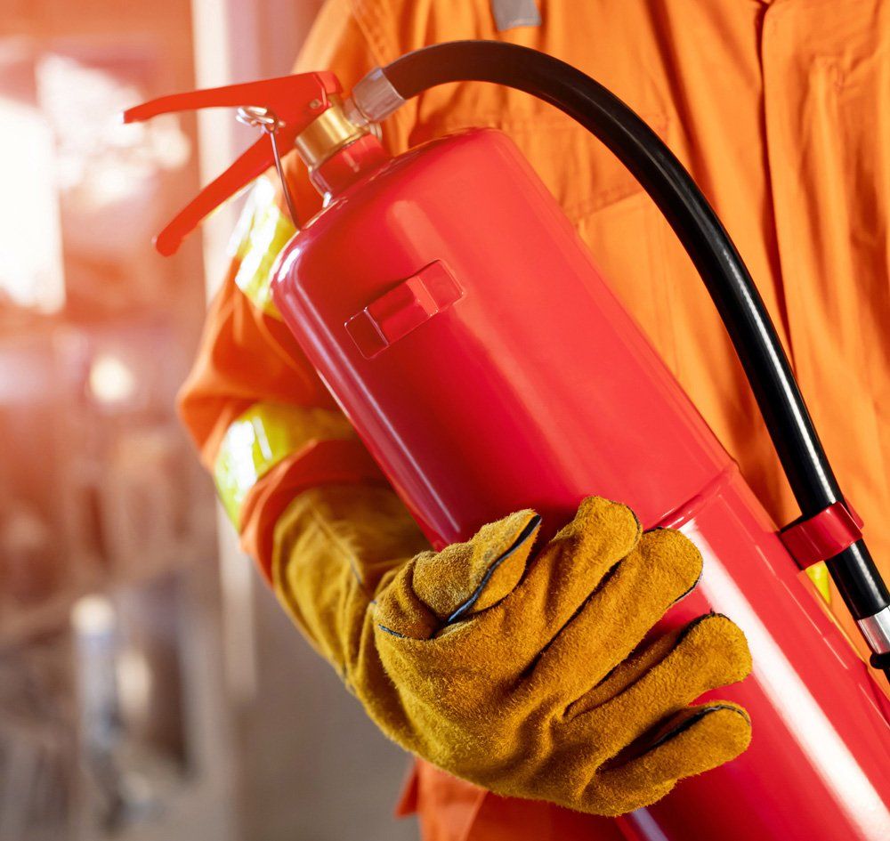 Holding Fire Extinguisher — Sydney, NSW — Eagle Fire Protection Pty Ltd