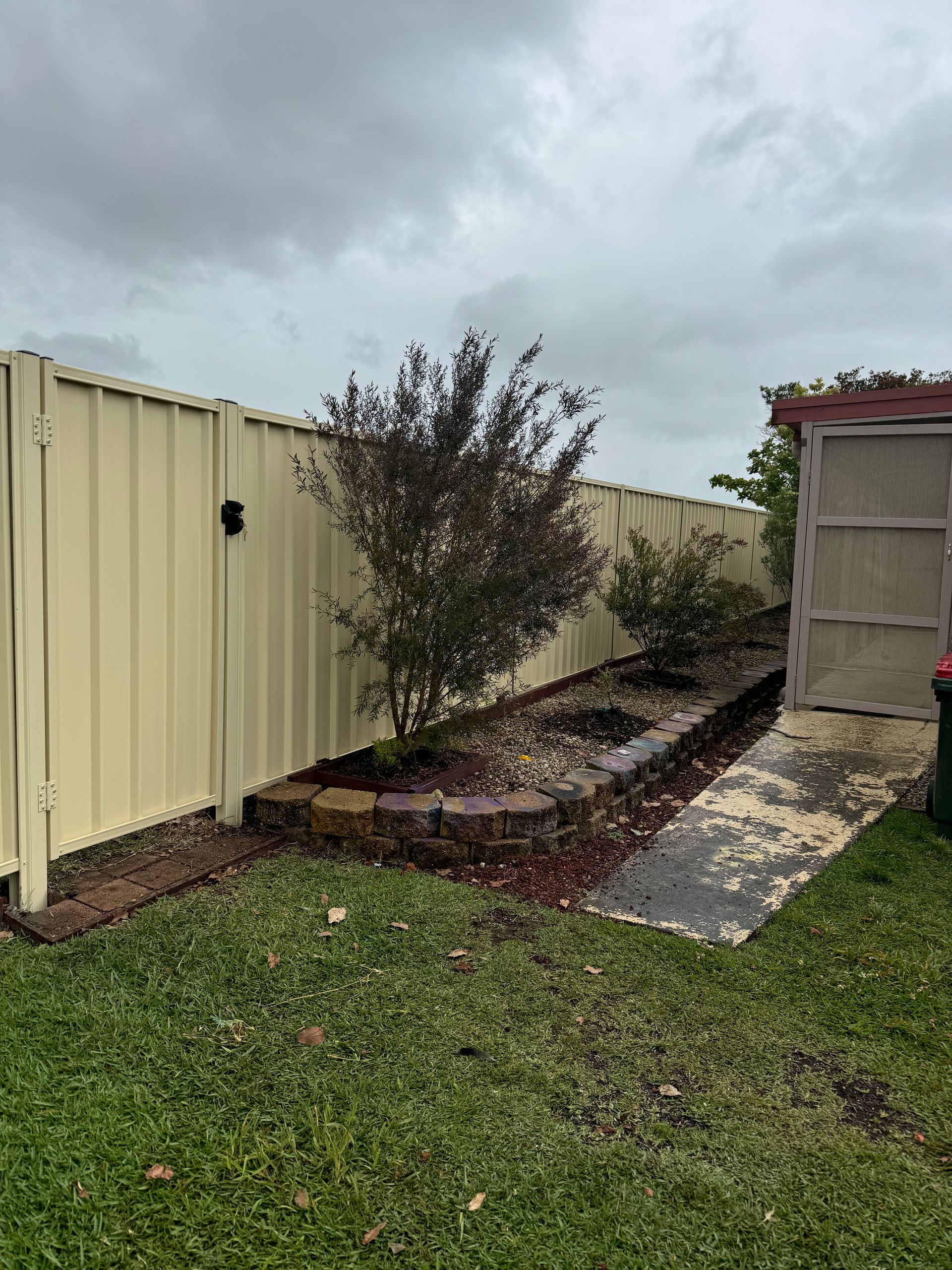 A Fence With A Gate And A Potted Plant Next To It — Mid Coast Boundary Fencing In Old Bar, NSW
