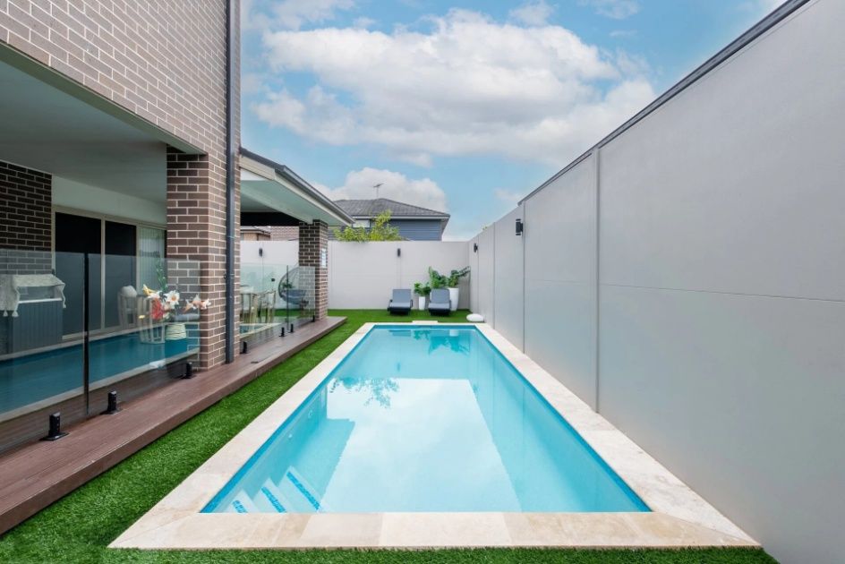 There Is A Large Swimming Pool In The Backyard Of A House — Mid Coast Boundary Fencing In Port Macquarie, NSW