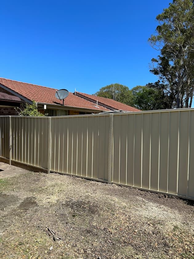 Fence With A Satellite Dish On Top Of It In Front Of A House - Colorbond Fence on the Mid North Coast, NSW