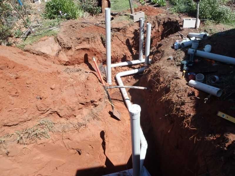 A Close Up Of A Bunch Of Blue Pipes And Valves Underground — Araluen Plumbing In Braitling, NT