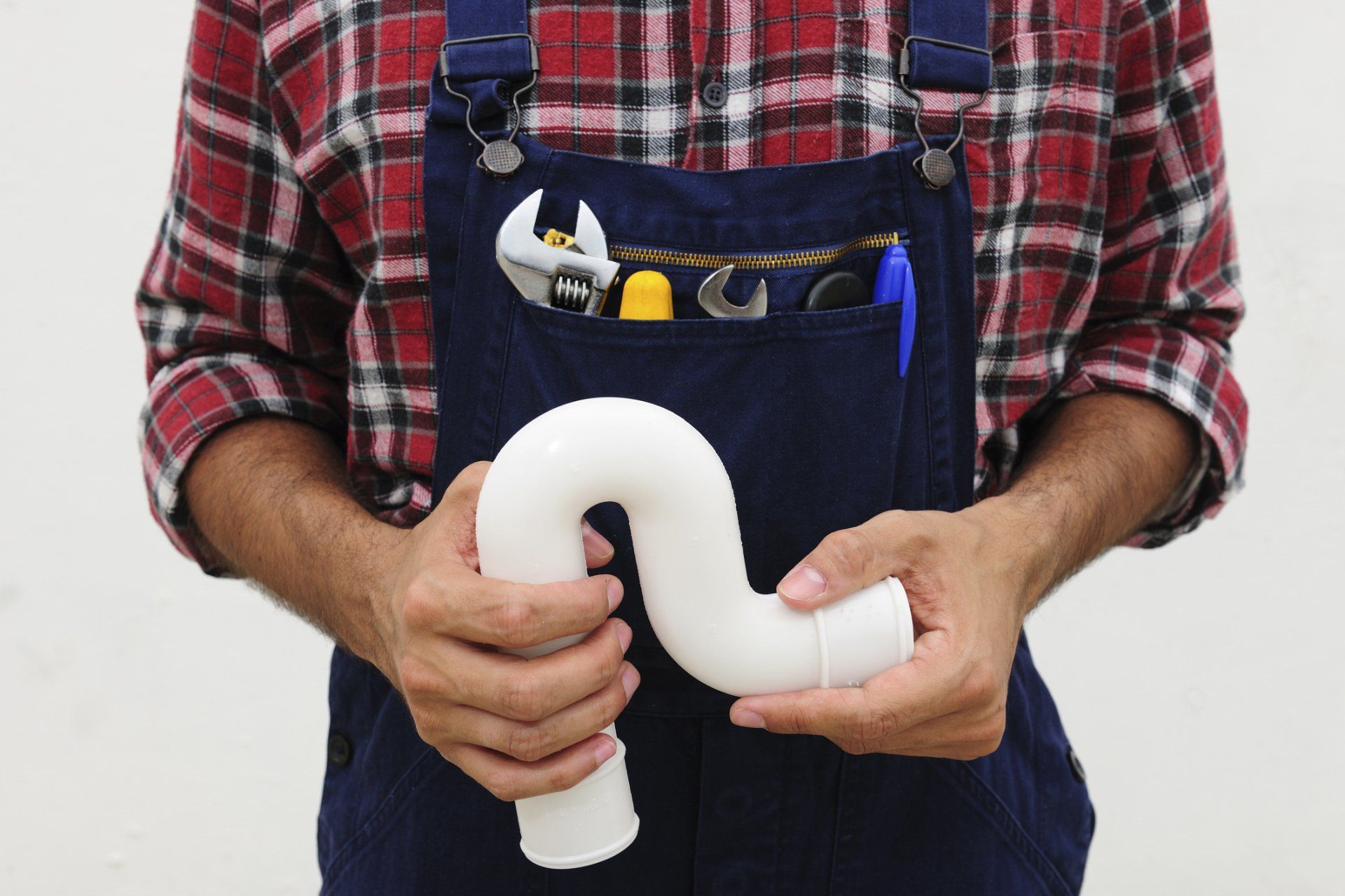 Plumbing — Plumber With Plastic U-Bend Pipe and Tools in Norfolk, VA