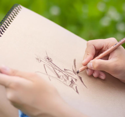 Drawing in a sketchbook for the Ocean City Arts Center summer camp for kids