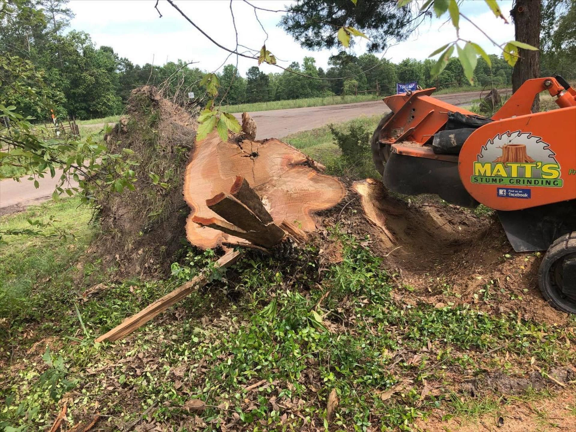 A tree stump is being removed by a machine.