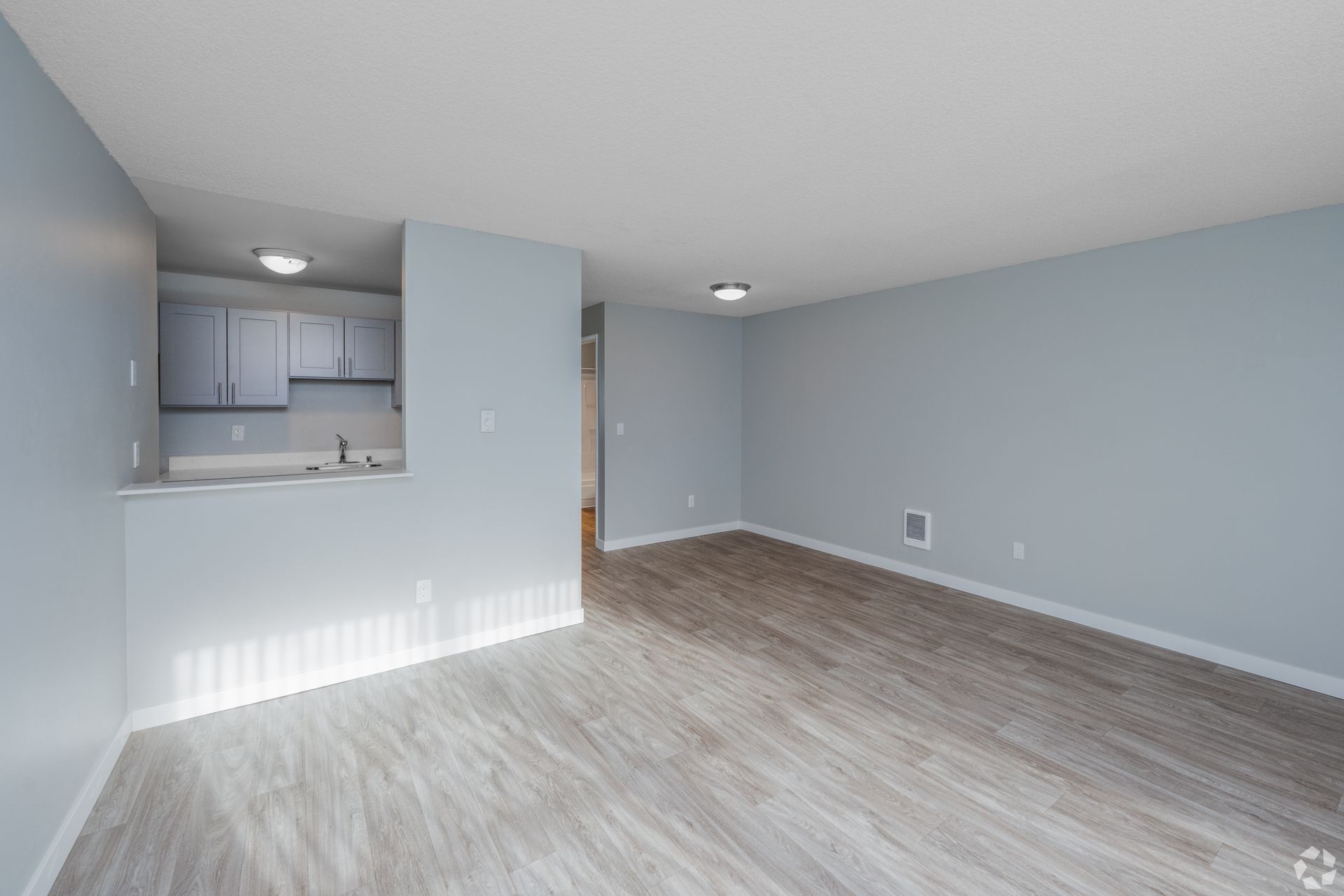 Bright, well lit room showing kitchen.