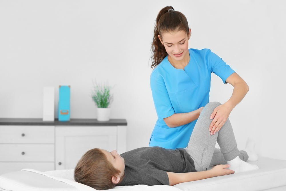 Female Physiotherapist Working With Young Patient — Physiotherapist in Bundaberg, QLD