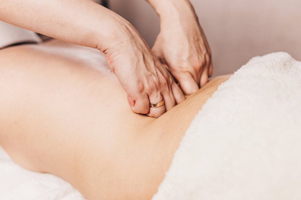 Physiotherapist Working on Patient's Back — Physiotherapist in Bundaberg, QLD