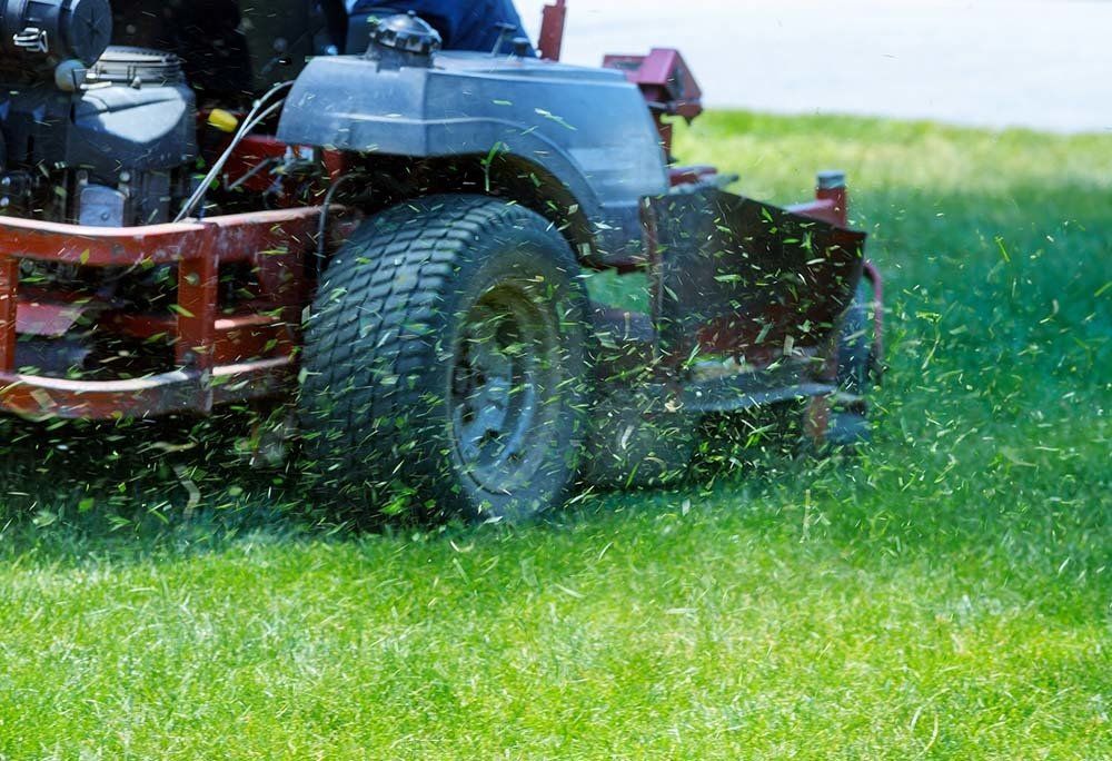 Red Lawn Mower Cutting Grass — Dayton, TX — Precision Lawns