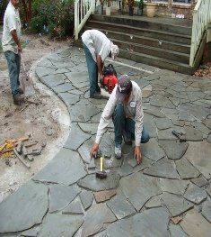 Group of Men Adding Rock Design on the Ground  — Dayton, TX — Precision Lawns