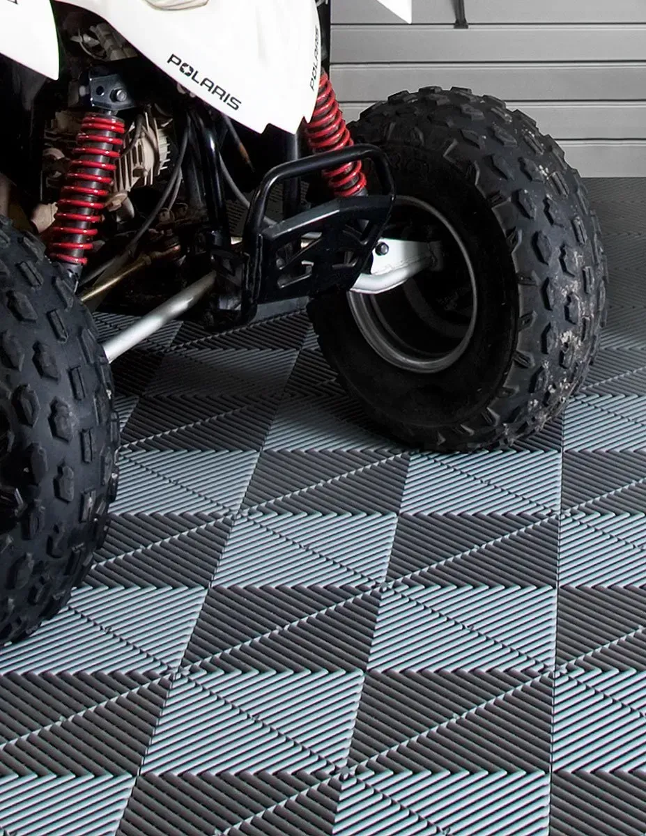 A polaris atv is parked on a checkered floor