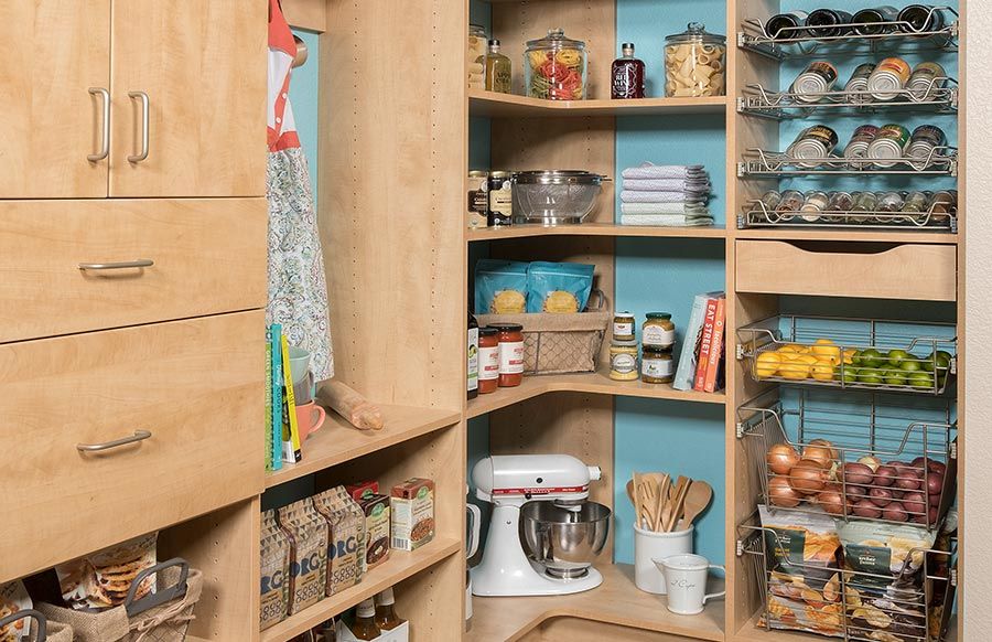 A pantry filled with lots of food and a mixer.