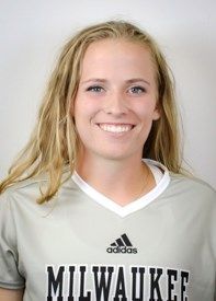 Blonde woman in a Milwaukee sports jersey smiling.