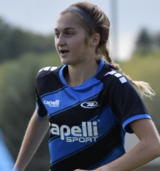 Soccer player in blue and black jersey looks to the side.