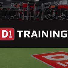 D1 Training logo on a black background, with gym equipment in the background and a red marker on a green surface.