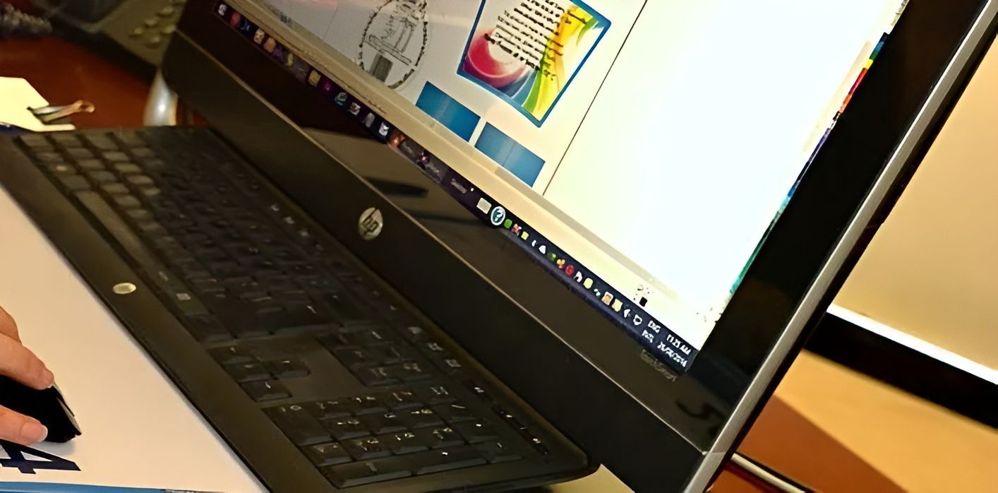 A person is typing on an HP laptop  — Aldine Printers in Bungalow, QLD