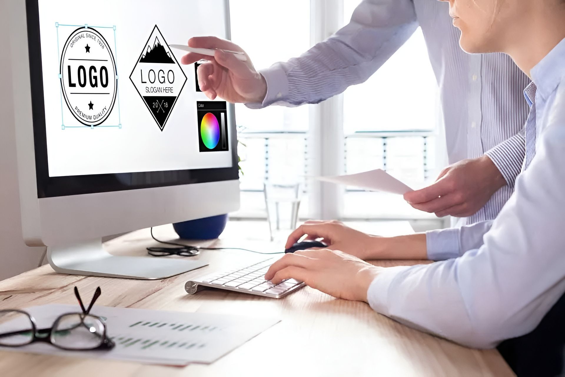 Designer+team+resizing+a+logo+for+marketing+and+branding