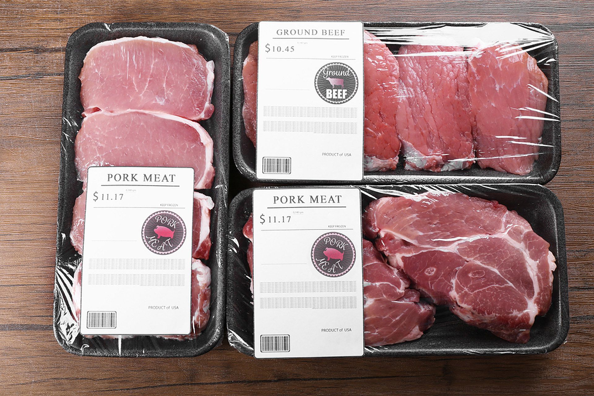 Four trays of pork meat are sitting on a wooden table — Aldine Printers in Bungalow, QLD