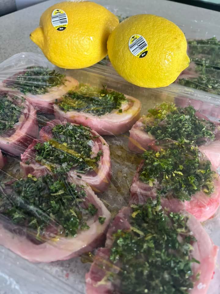 A Plastic Container Filled With Meat and Lemons on a Table — Aldine Printers in Bungalow, QLD