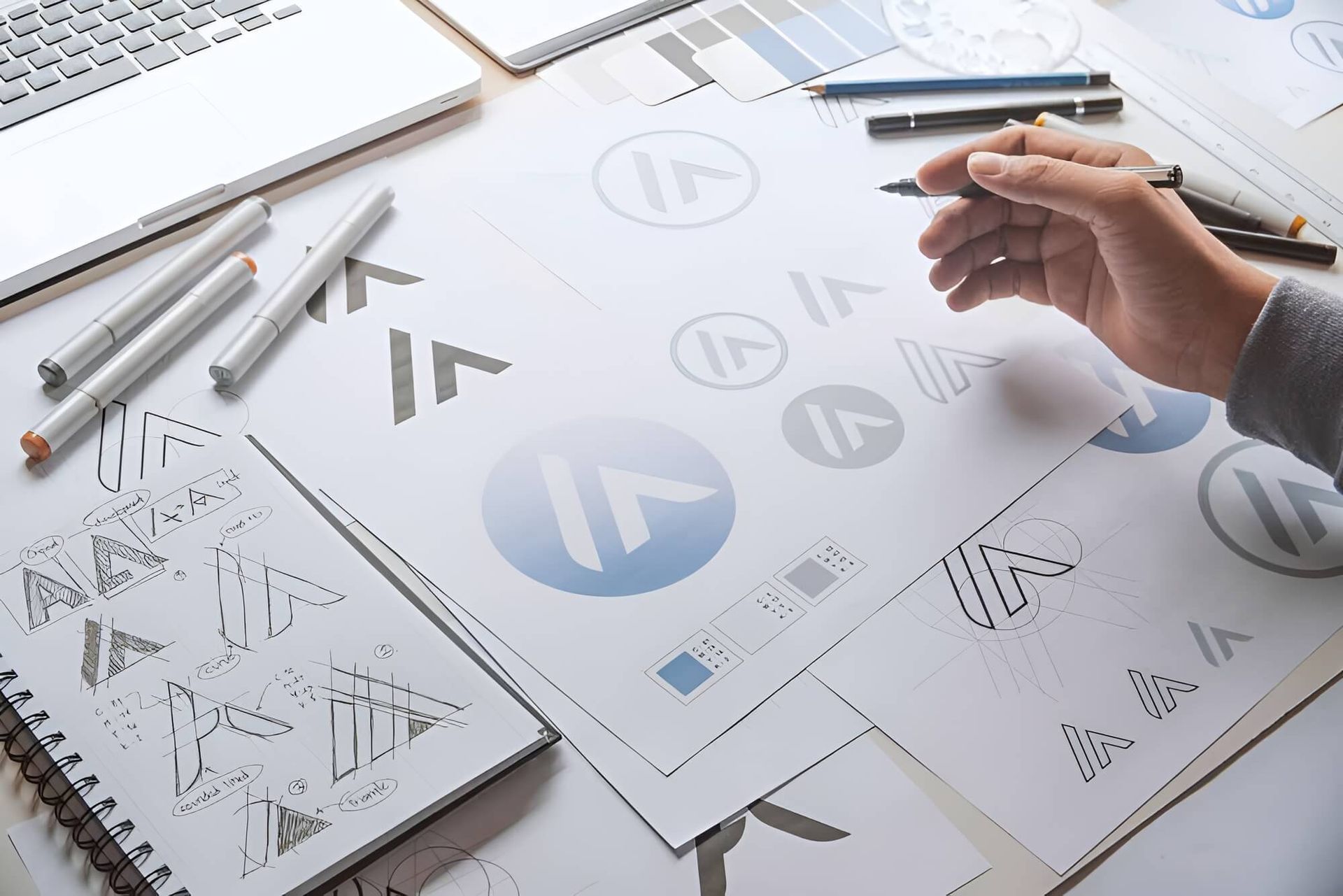 A Person is Drawing a Logo on a Piece of Paper — Aldine Printers in Bungalow, QLD