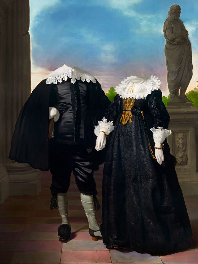 Formal black outfits, headless figures stand on a terrace, statue in background.
