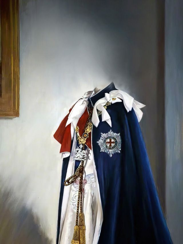 Royal cape with sash and emblem hanging against a light wall.