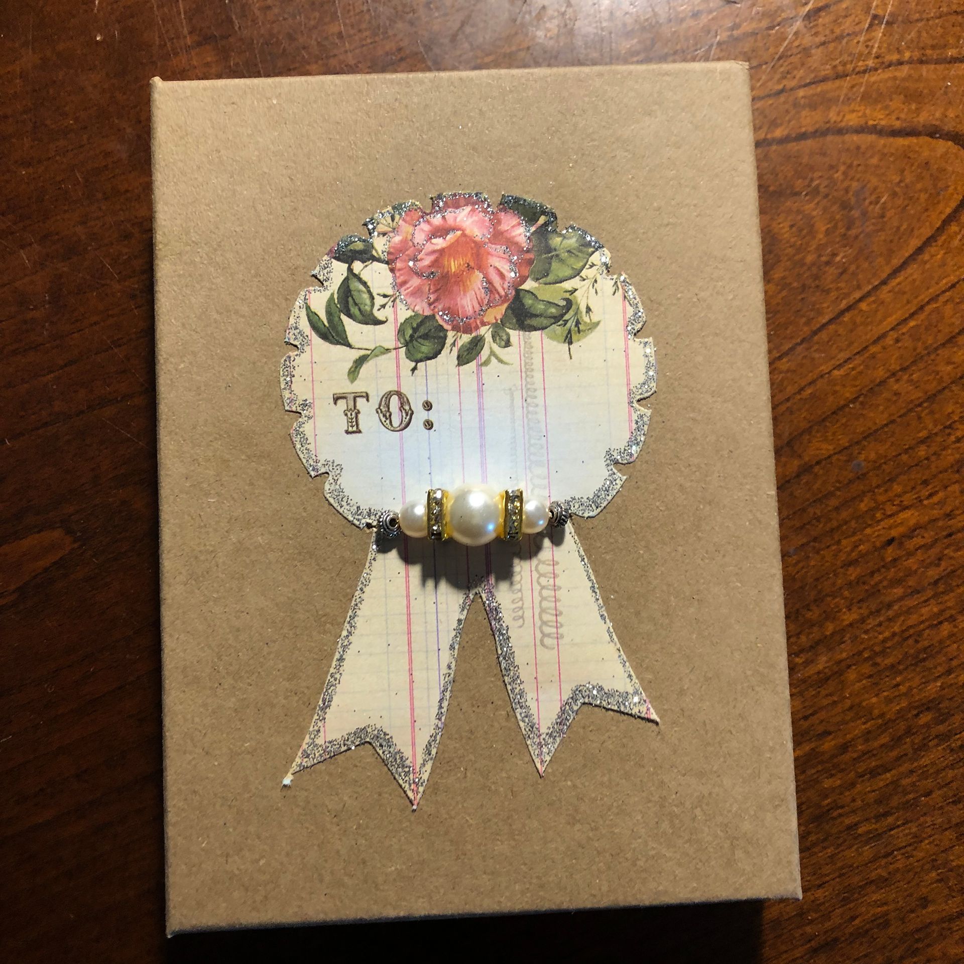 Brown gift box with decorative floral embellishment and 