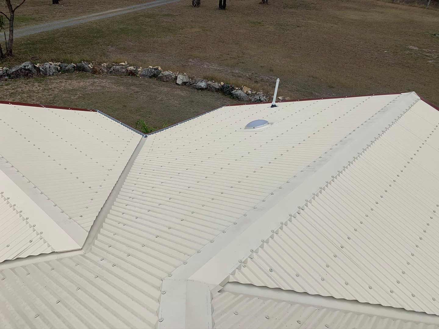An Aerial View of a White Corrugated Metal Roof With a Skylight — Ben McLennan Constructions in Grafton, NSW