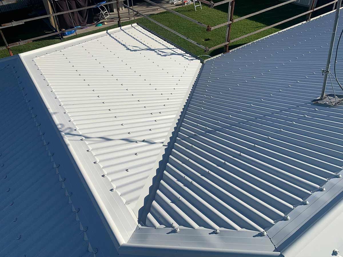 A White Roof With a Blue Gutter on a House — Ben McLennan Constructions in Grafton, NSW