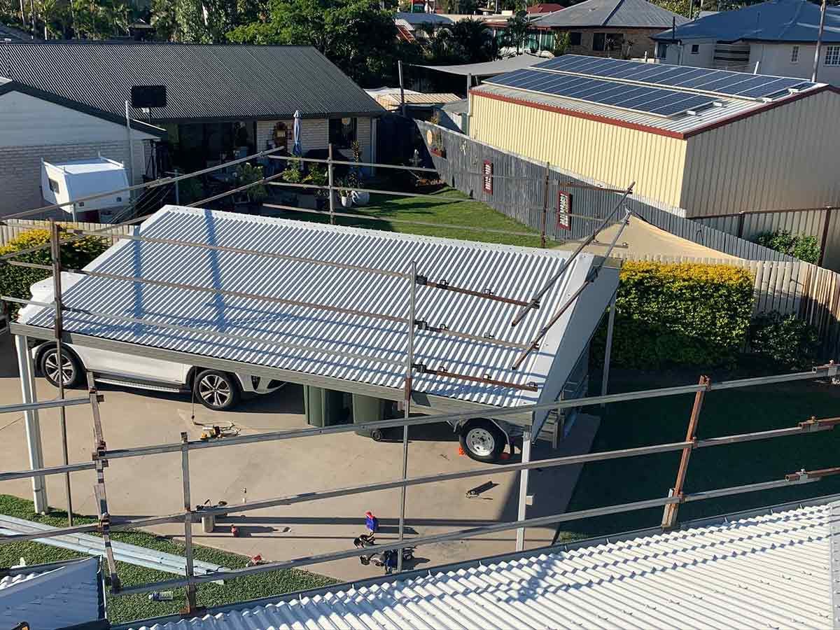 A White Truck is Parked in Front of a House With a Roof That is Being Built — Ben McLennan Constructions in Grafton, NSW