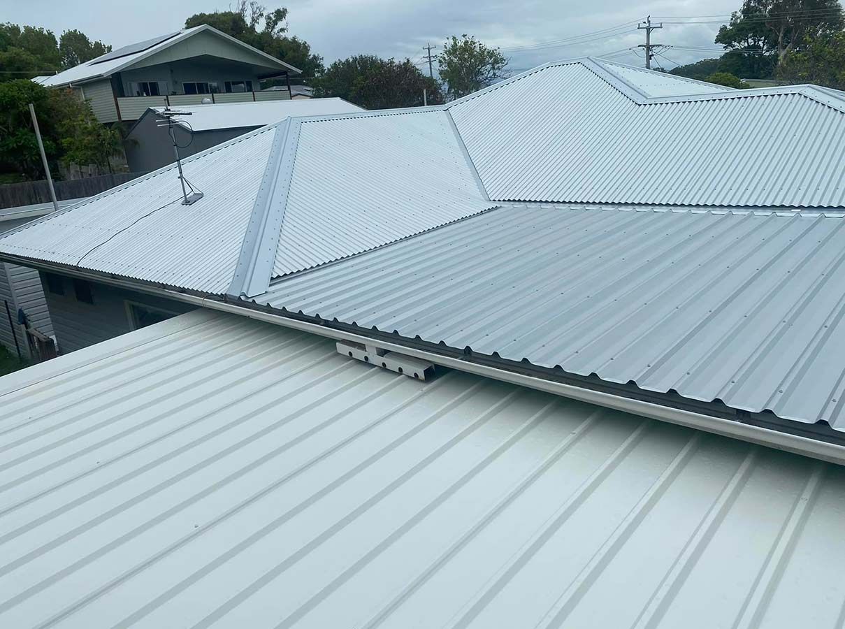 A White Roof With a Black Trim is Sitting on Top of a House — Ben McLennan Constructions in Ballina, NSW