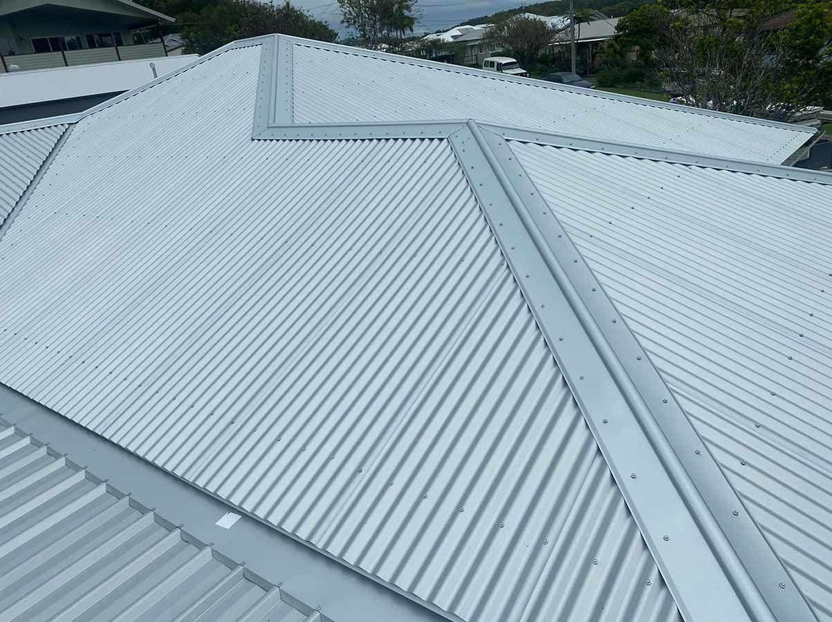 A White Metal Roof With a Triangle Shaped Ridge — Ben McLennan Constructions in Grafton, NSW