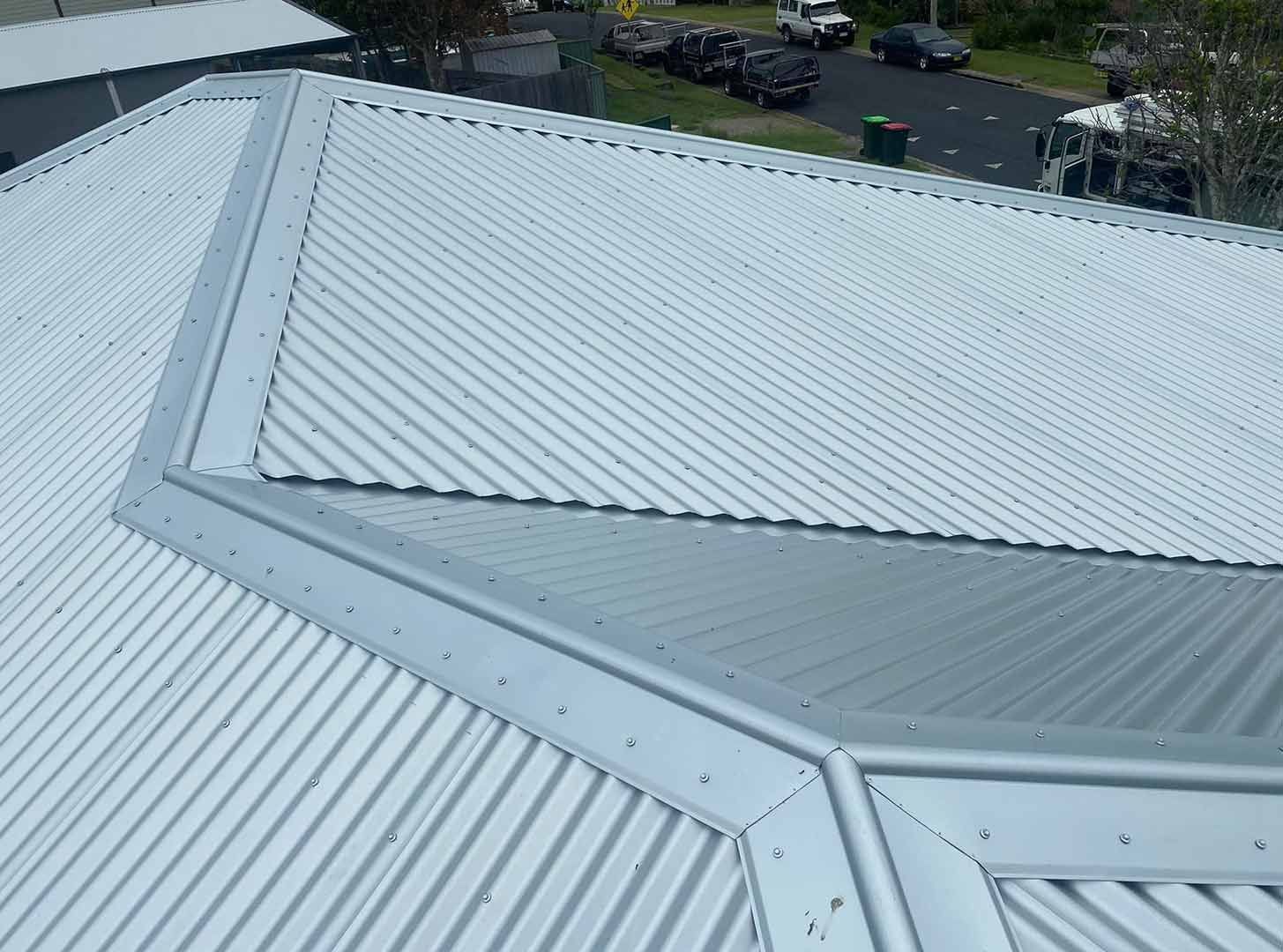 A White Metal Roof With a Triangle Shaped Corner — Ben McLennan Constructions in Grafton, NSW