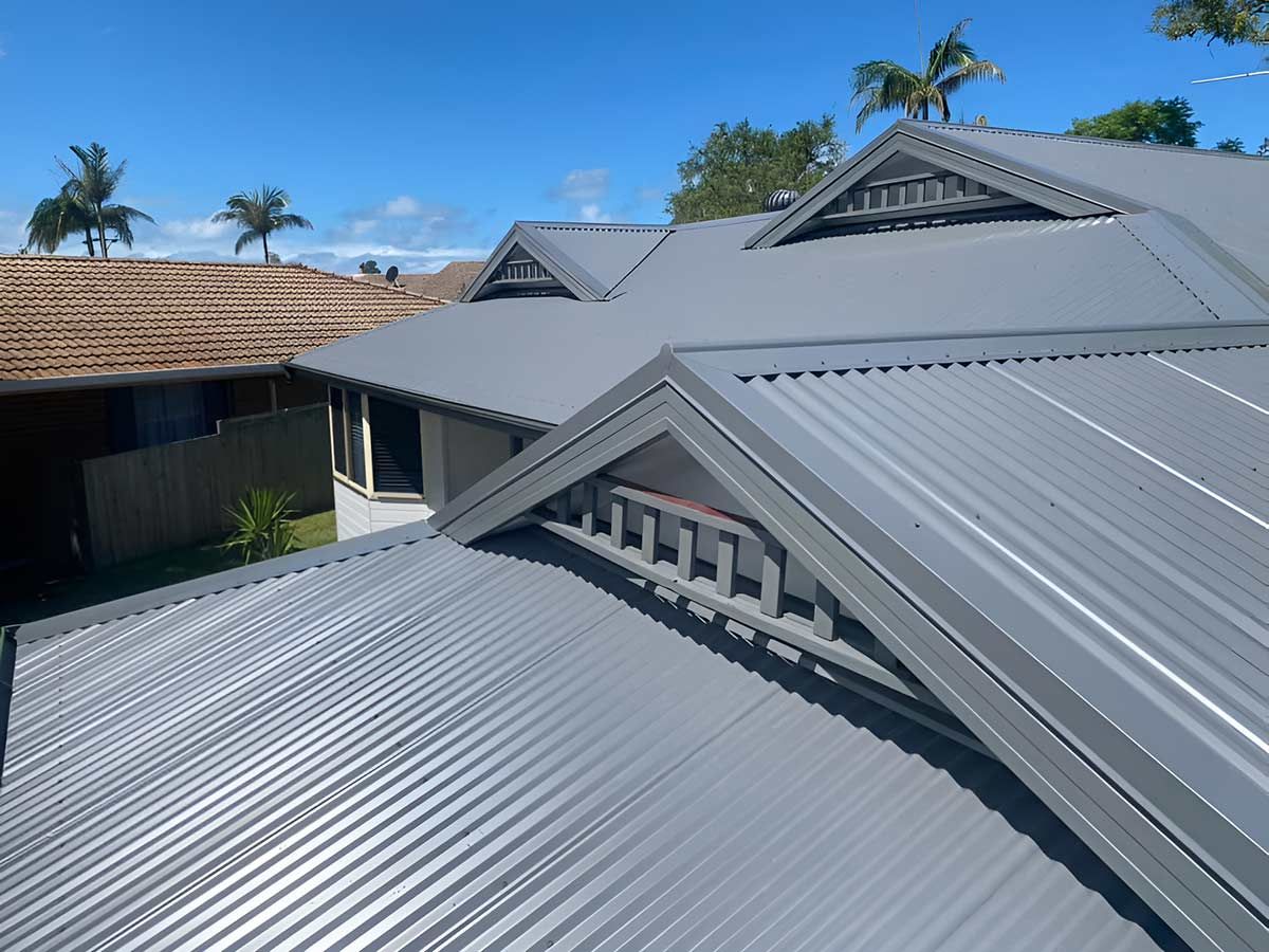 A House With a Gray Roof and Palm Trees in the Background — Ben McLennan Constructions in Grafton, NSW