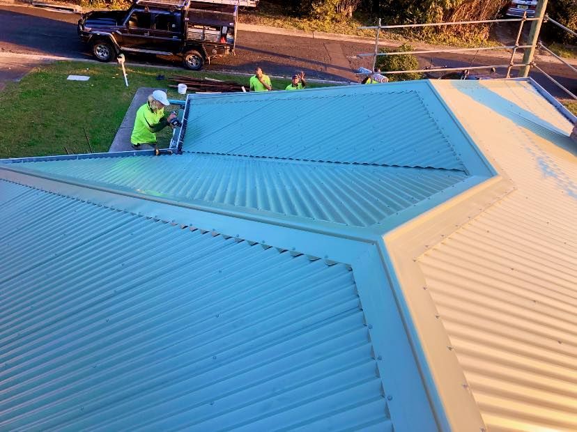 A Group of Men Are Working on the Roof of a House — Ben McLennan Constructions in Tweed Heads, NSW