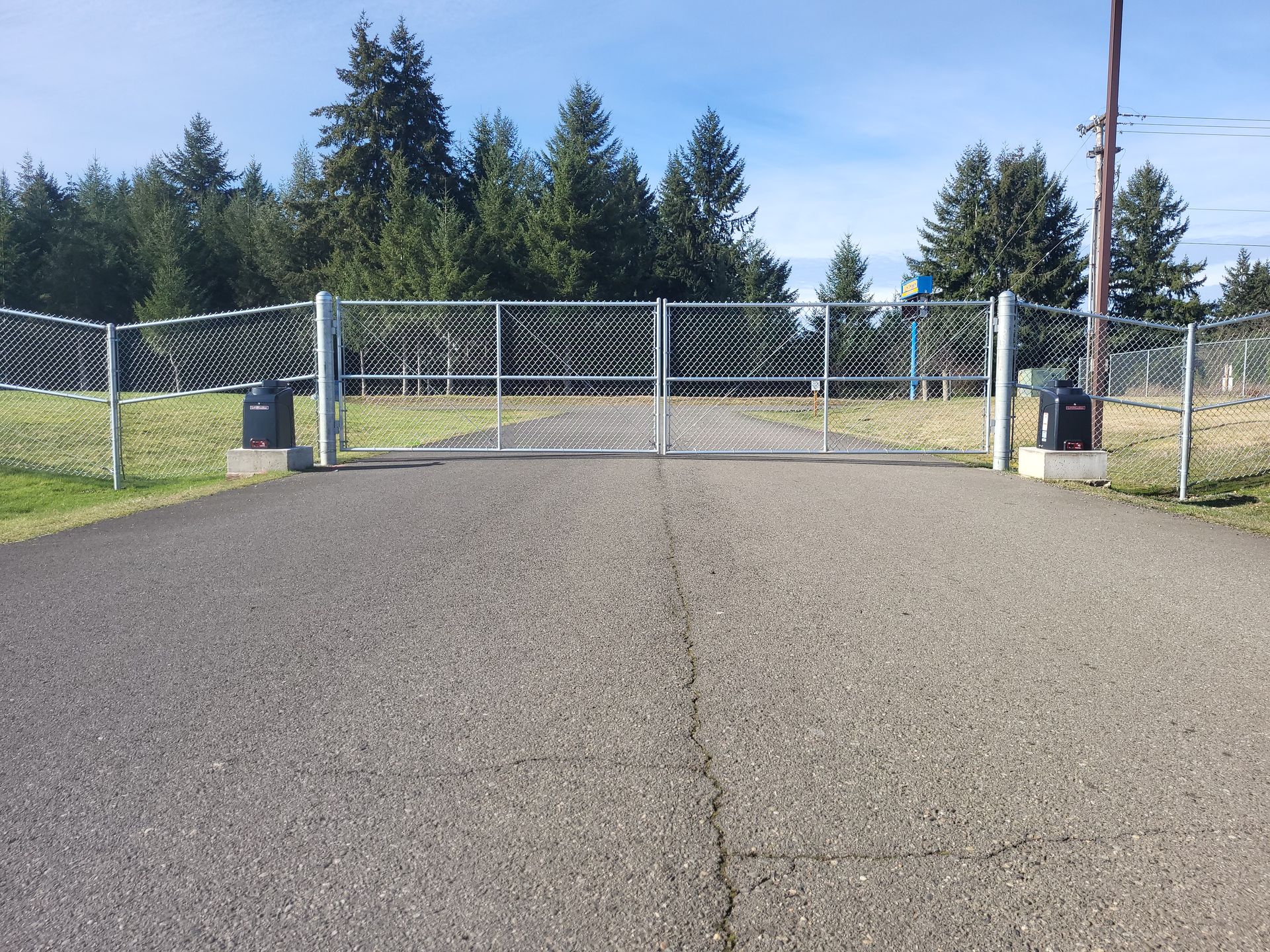 Road With White Chain Link — Rochester, WA — Chehalis Fencing Inc