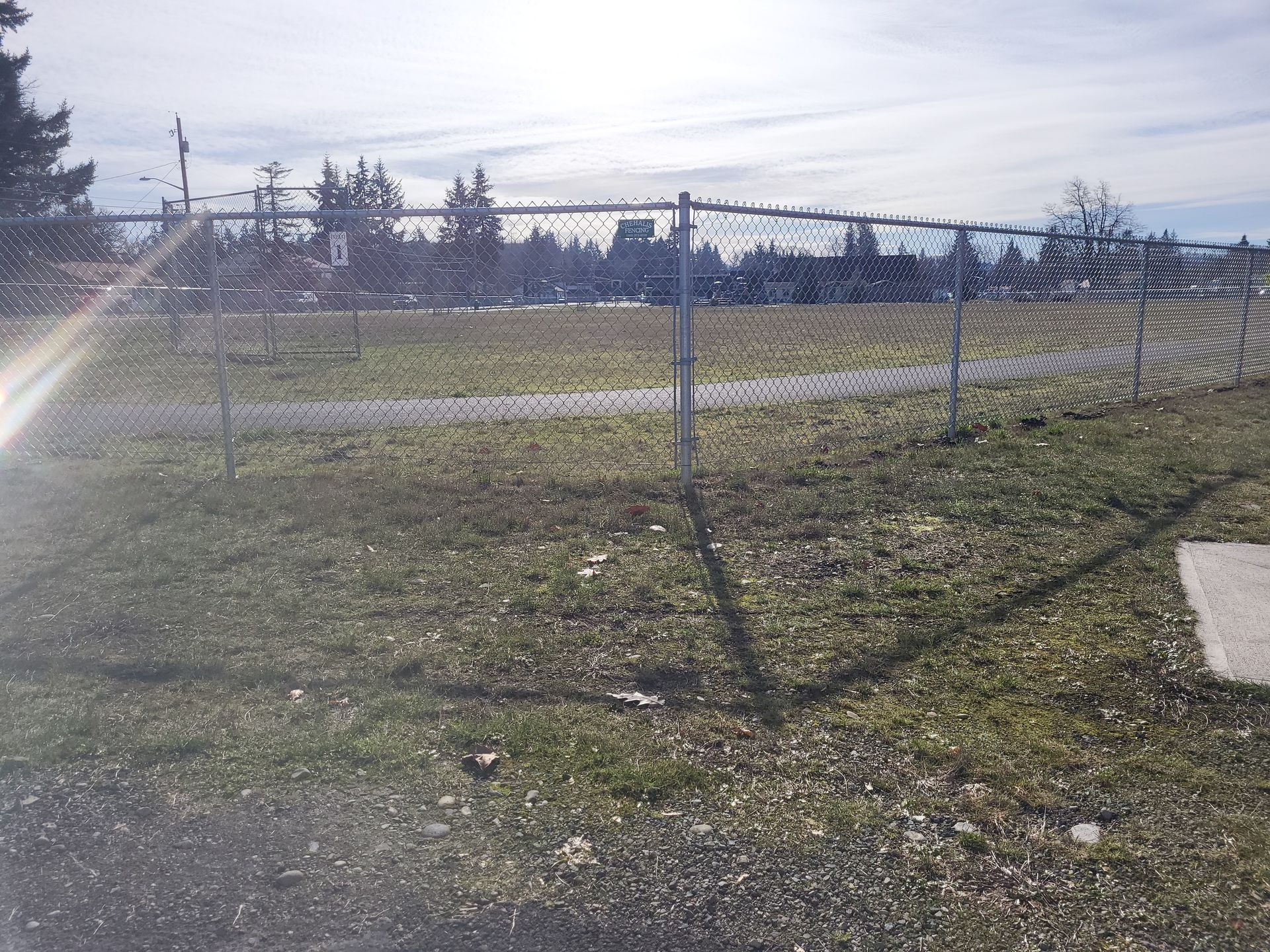 Green Field With Chain Fence — Rochester, WA — Chehalis Fencing Inc