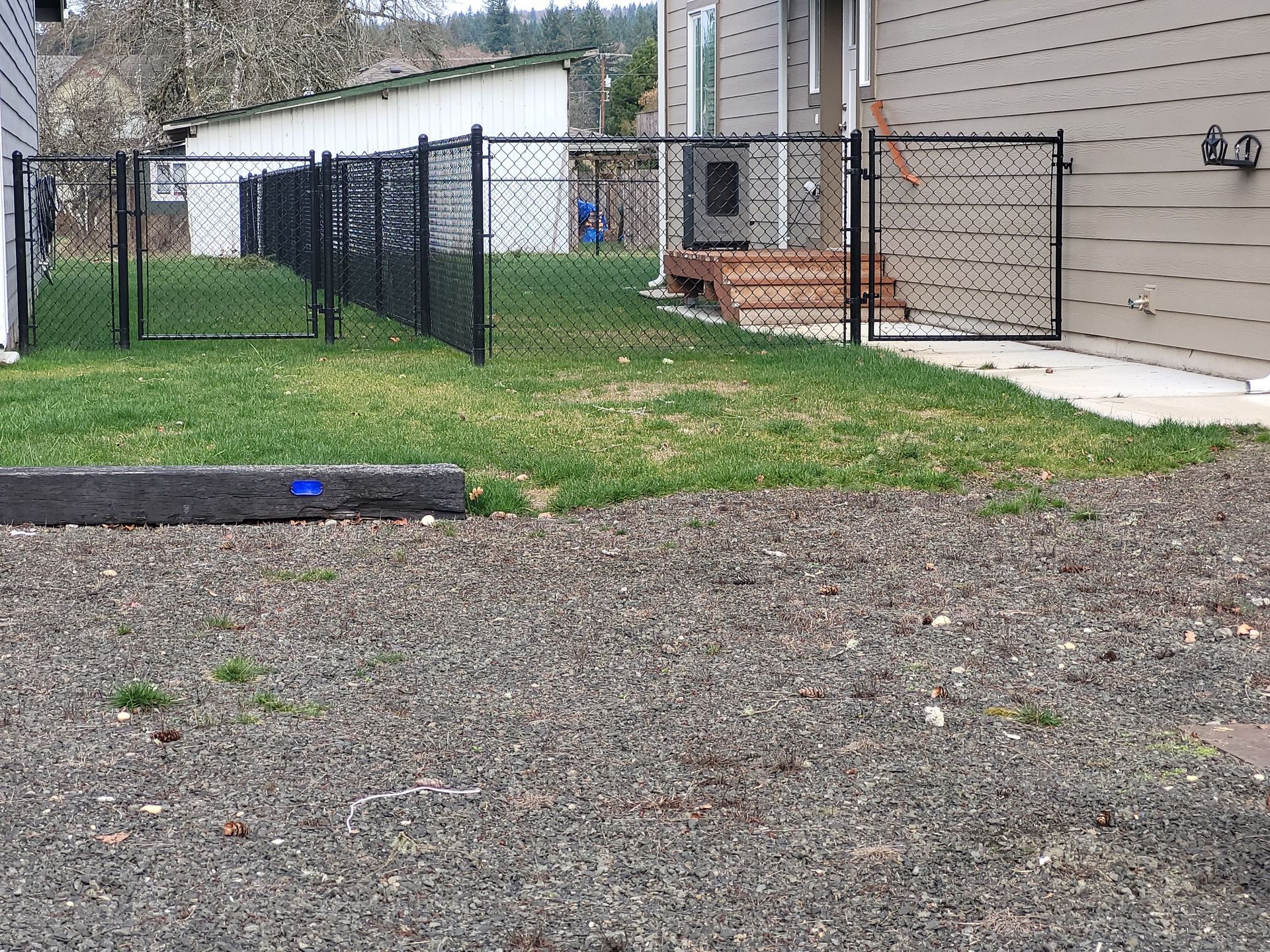 Home With Black Chain Link Fence — Rochester, WA — Chehalis Fencing Inc