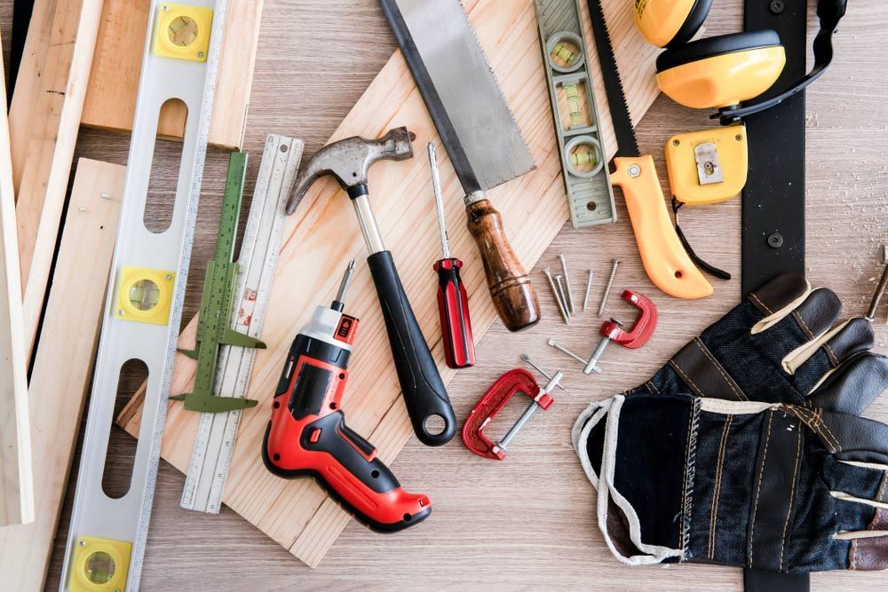 A Bunch Of Tools Are Laying On A Wooden Table — All Trades Equipment In Lismore, NSW