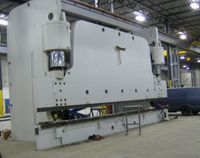 A large metal object is sitting on top of a concrete floor.