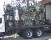 A large machine is hanging from the ceiling of a building.