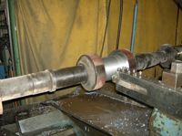 A machine is cutting a piece of metal on a table.