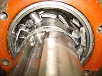 A close up of a metal object with a bearing on it.