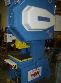 A blue and yellow machine is sitting in a room.