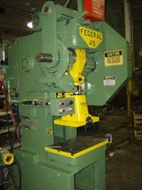 A green and yellow machine with the word federal on it.