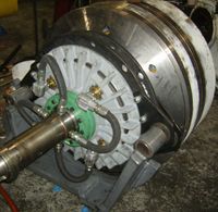 A large machine is sitting on top of a table in a garage.